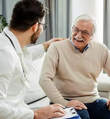 Joint Genesis happy elderly man with doctor